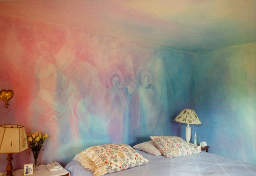 bedroom with pink and blue mural